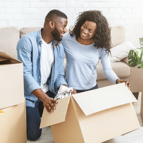 Excited black couple getting ready for moving out