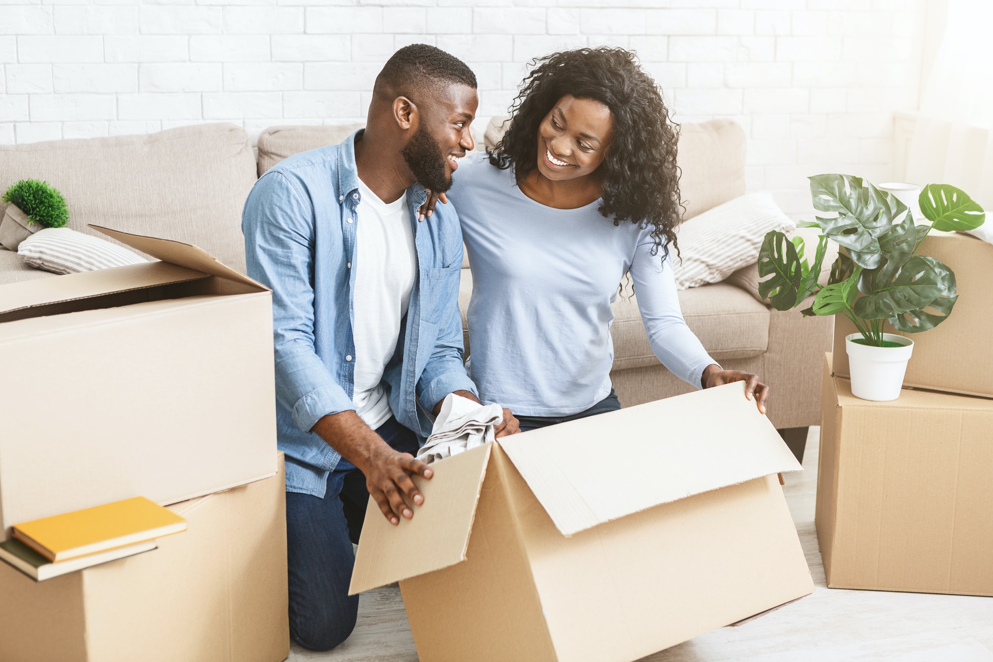 Excited black couple getting ready for moving out
